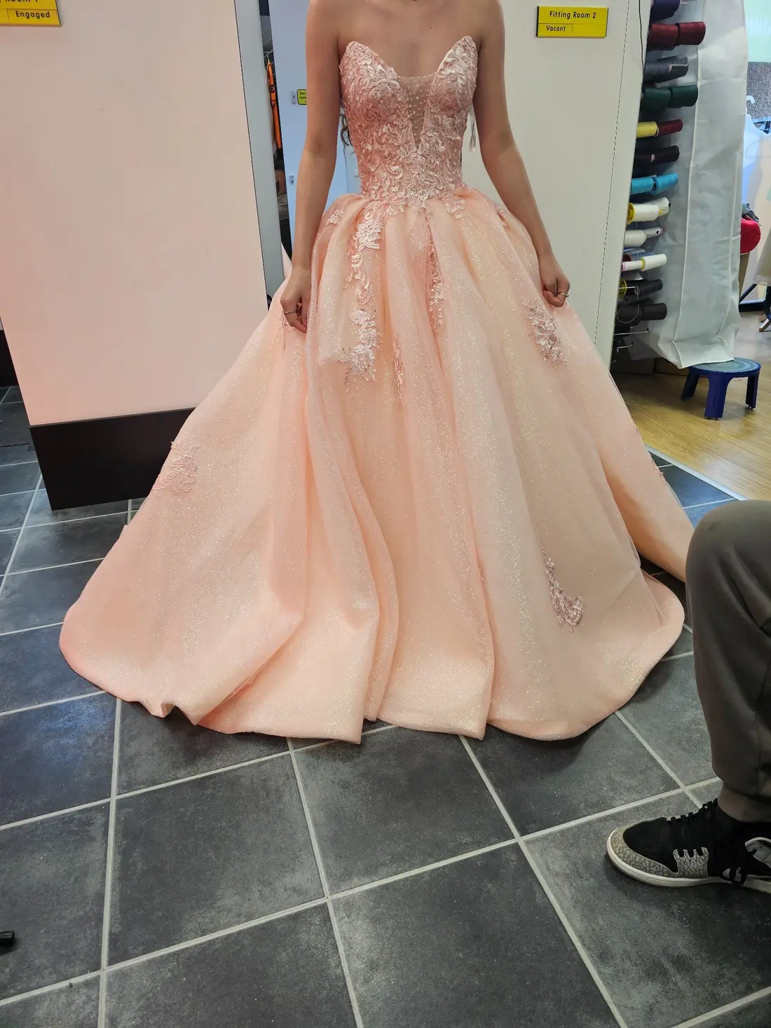 A peach embroidered ball gown with a carefully fitted bodice