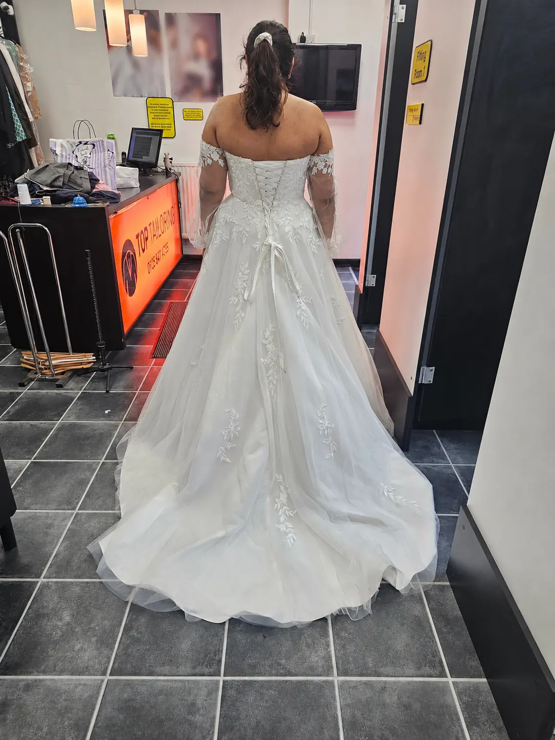 The corset fit and train of a white wedding dress