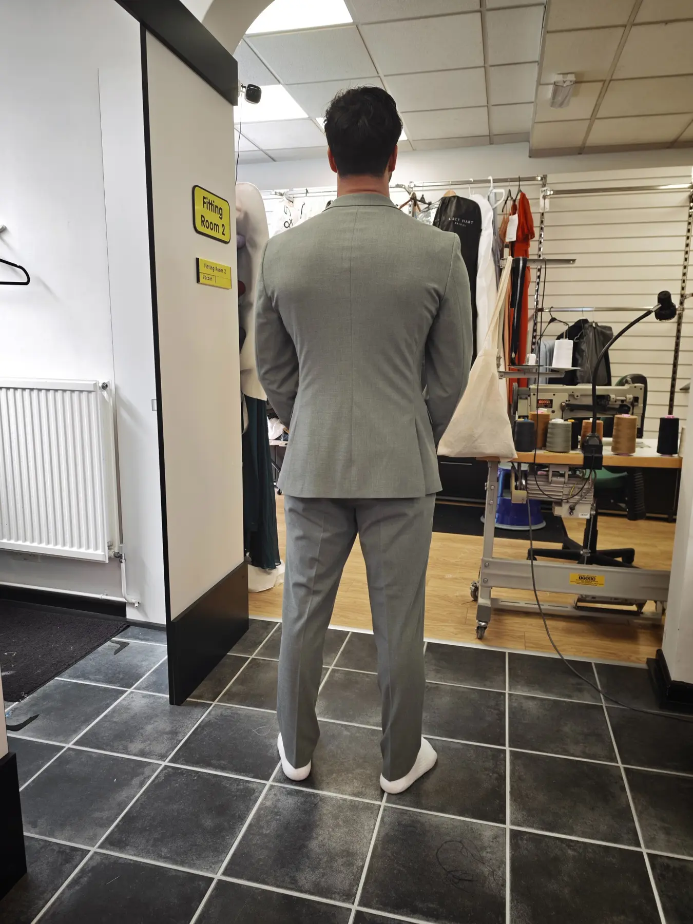 The shaped back of a light-grey suit
