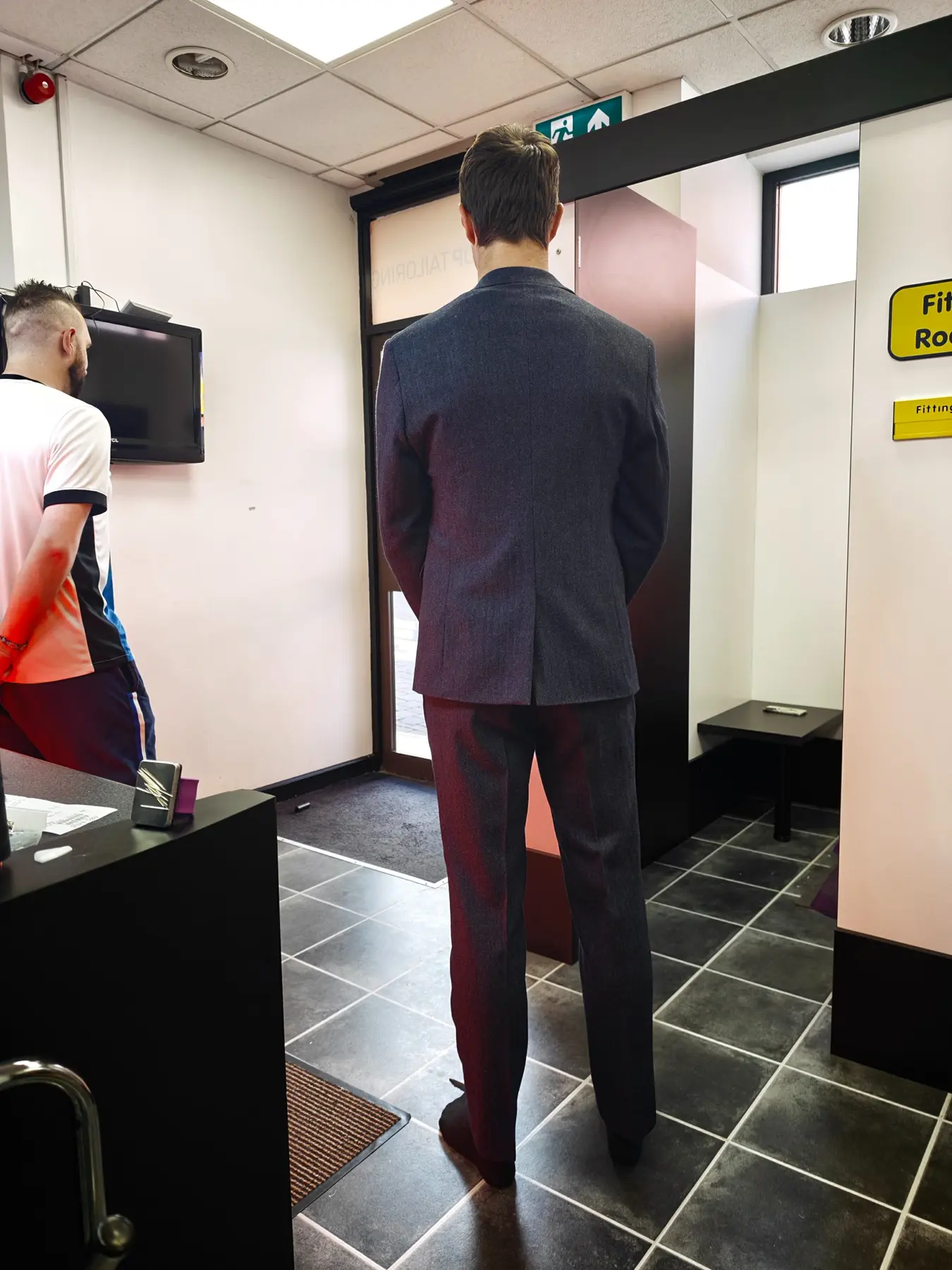 The clean back fit of a navy three-piece suit