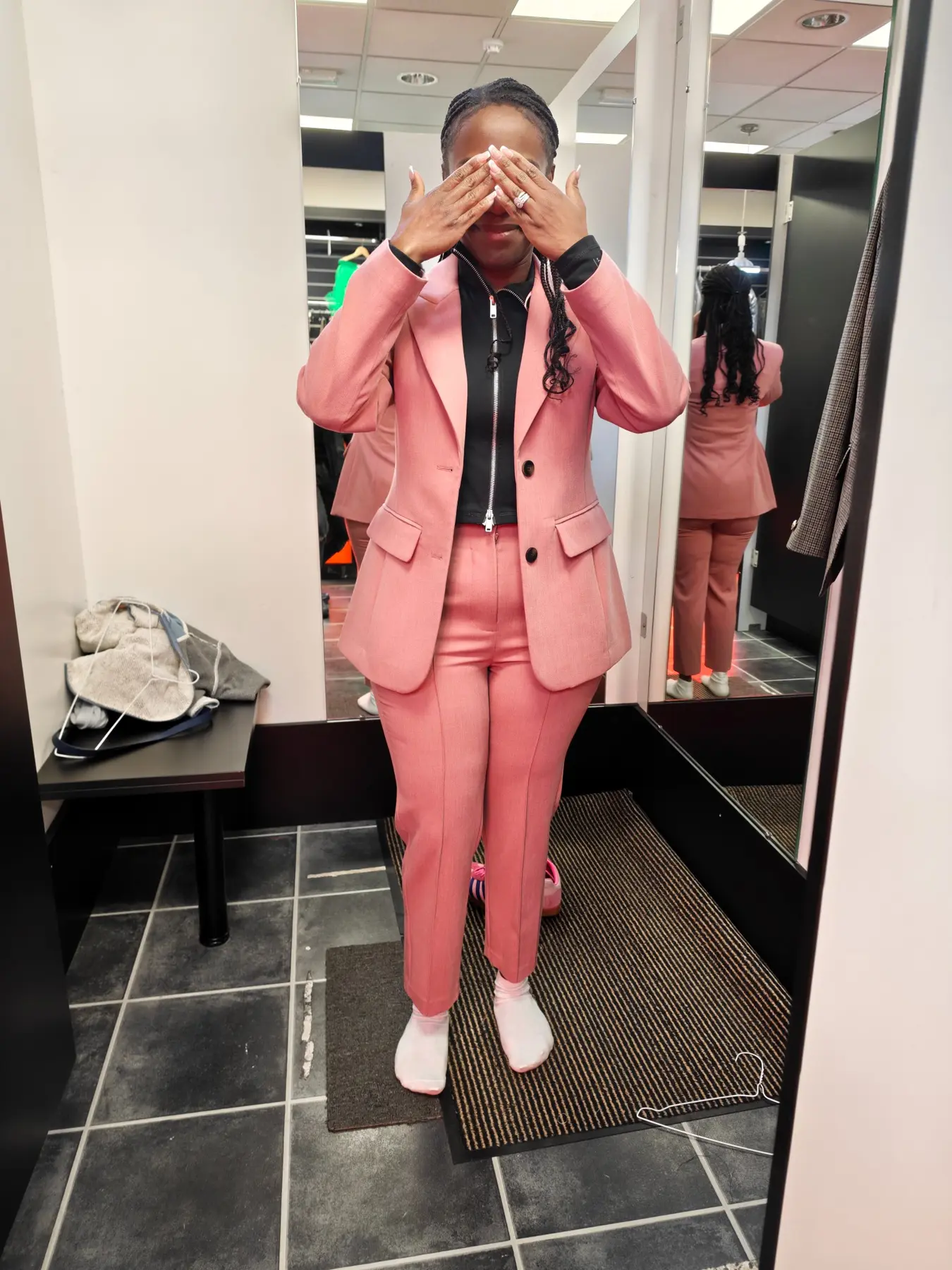A coral-pink trouser suit after tailoring