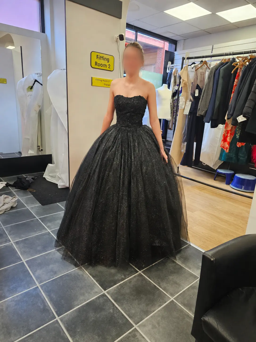 A black sparkle ball gown after fitting