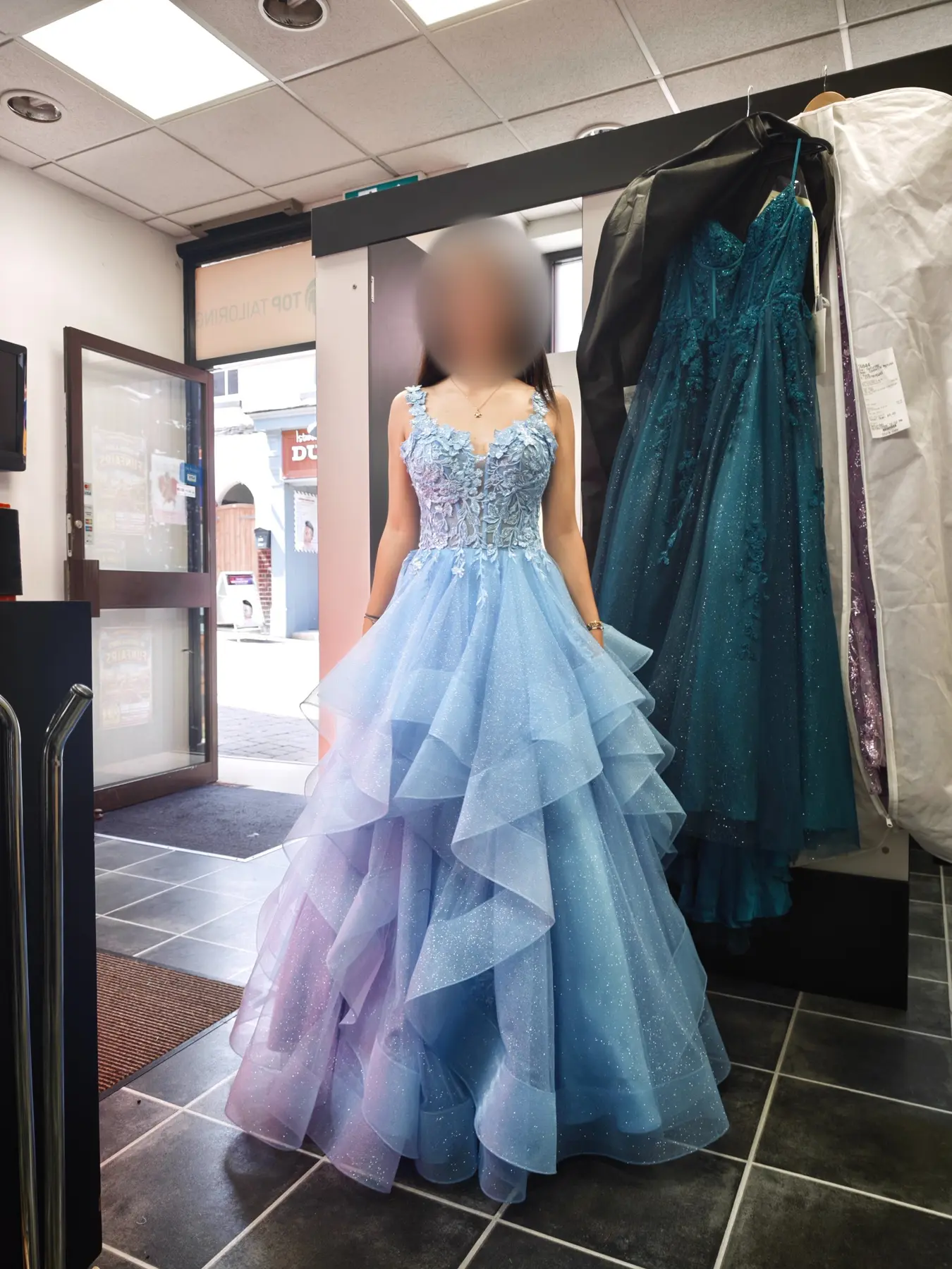 A fitted pale-blue layered prom gown