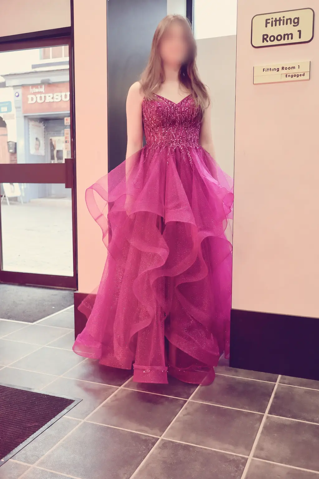 A purple layered occasion gown after fitting