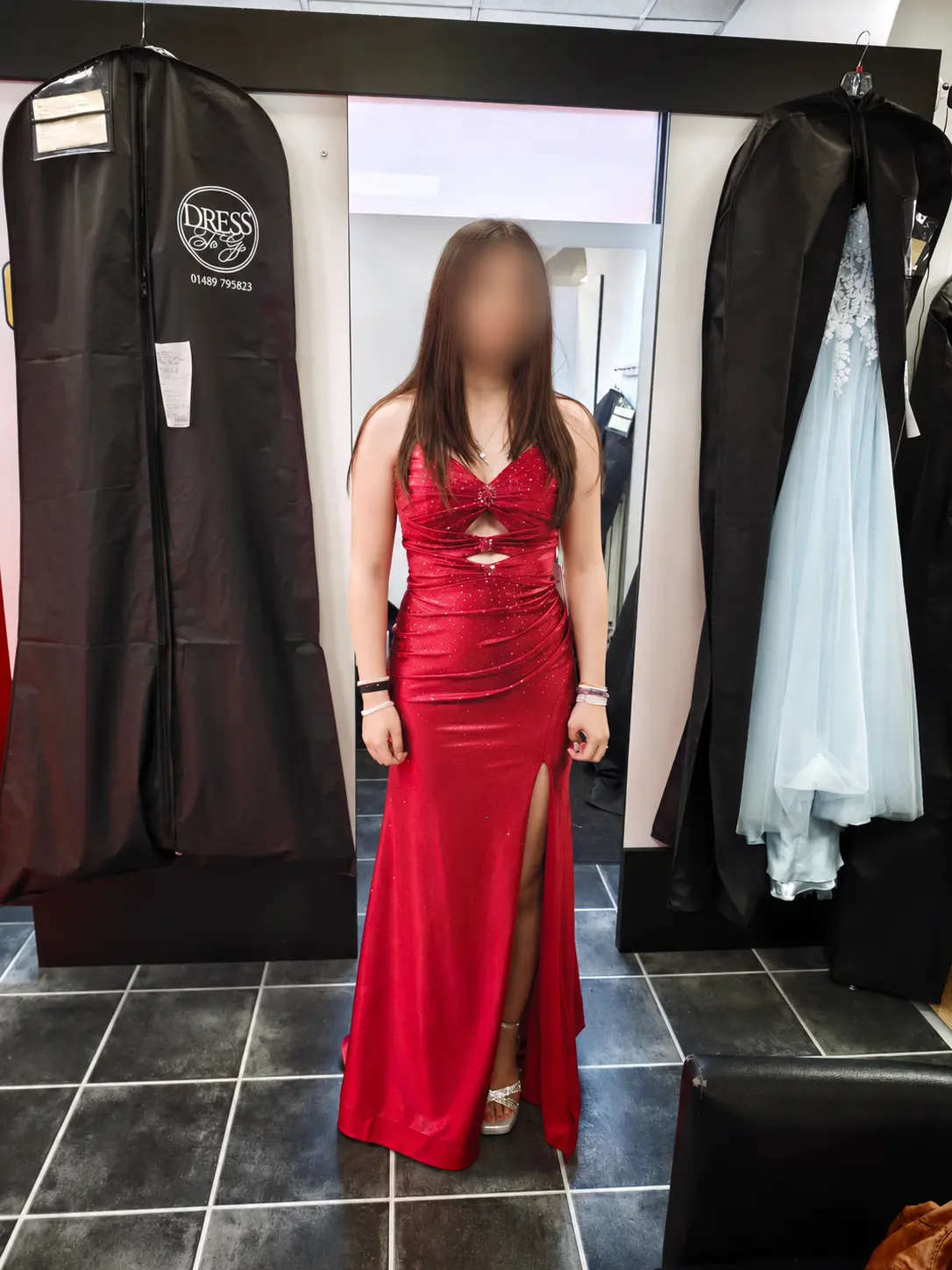 A fitted red sparkle prom dress